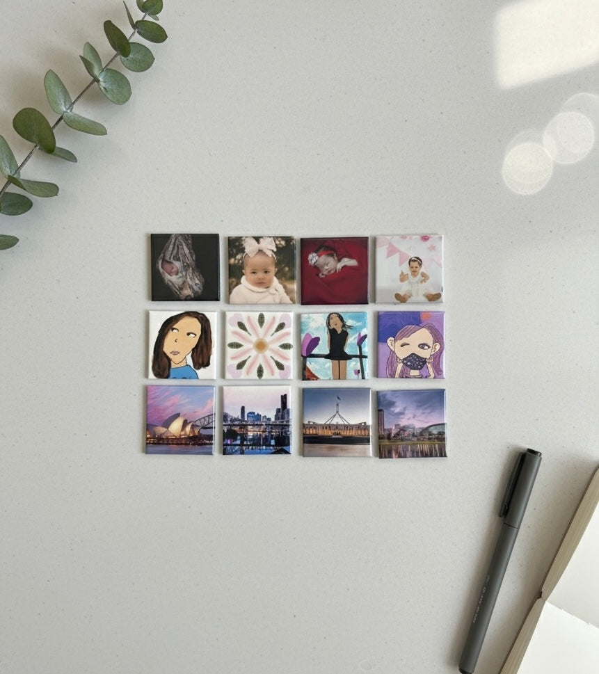 Flatlay of twelve Magnipix custom 2x2 photo magnets arranged in a clean grid on a white desk.